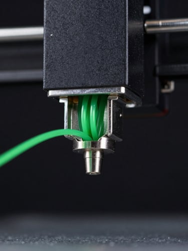 Extreme macro close-up of a 3D printer nozzle extruding bright green polymer filament, sharp focus, moody low-key studio lighting with key lights highlighting the metallic nozzle edge, dark background