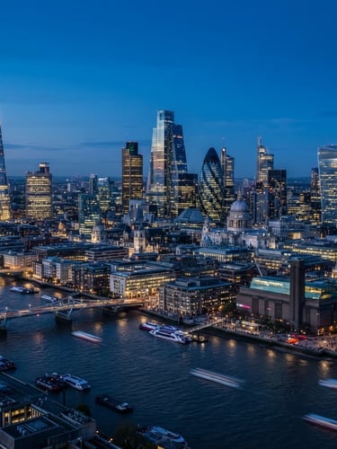 High-angle panoramic view of modern London skyline at blue hour, sleek glass skyscrapers reflecting city lights, a subtle focus on architectural precision, cool blue tones.