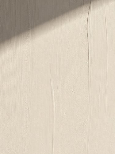 Extreme macro close-up of a hand-applied lime wash wall texture in warm chalky white, soft morning shadows casting across the subtle mineral ridges, architectural minimalist composition.