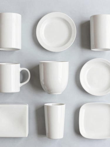 Clean flat-lay of hand-selected home and lifestyle products, neatly organized on a light grey background, soft natural daylight, crisp details