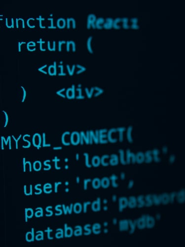 Macro close-up of clean, high-contrast React code on a dark-mode IDE screen, cool cyan terminal glows reflecting off dark glass, sharp focus on database connection strings, low-key dramatic lighting.