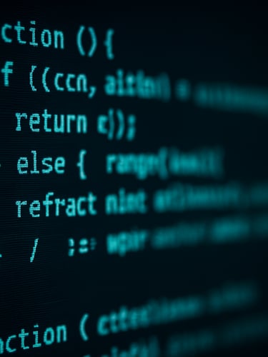 Macro close-up of clean code on a high-resolution screen in a dark room, cool cyan terminal glow, sharp focus