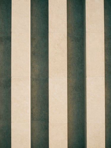 Abstract architectural structure of interlocking stone pillars, clean lines, casting soft geometric shadows on a warm ivory wall, minimalist fine art photography, 35mm