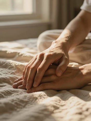 Intimate close-up of hands resting together on a soft linen blanket, warm diffused golden hour light filtering through a window.