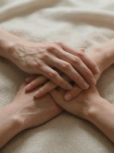 A close-up of two hands resting gently together on a soft wool blanket, warm diffused natural light