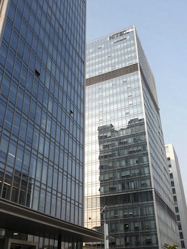 Wide-angle editorial shot of the modern glass facades in HITEC City, Hyderabad, captured in bright morning light with clean geometric lines, 35mm.