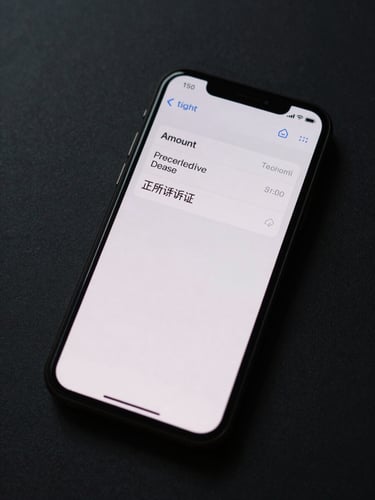 Tight overhead crop of a phone screen displaying an SMS alert reading amount, recipient name, status confirmed, and a precise timestamp, device-screen lit against a dark matte surface, no hands, flat studio fill light from above
