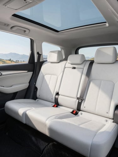 Interior of a clean, modern white SUV showing pristine leather seats, spacious cabin, sunlight streaming through windows, professional and comfortable atmosphere