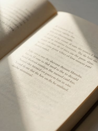 Overhead macro shot of an open book showing beautiful typography texture on warm cream paper, soft directional natural window light, 35mm