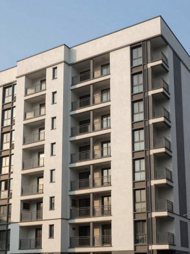 Wide architectural perspective of modern multi-story residential apartments in Dwarka Sector 19B under bright afternoon sun, clean lines, structured layout.