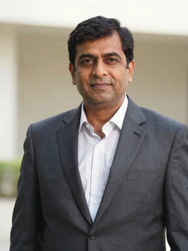 A professional portrait of Mr. Rohit, a real estate expert with ten years of experience, dressed in a tailored corporate suit, natural daylight, soft architectural background.