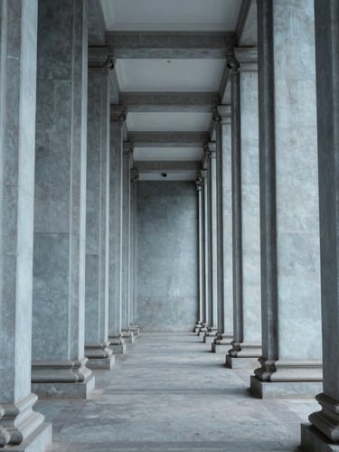 An orthographic, straight-on view of architectural structural columns under cool, clear, overcast daylight, emphasizing order, scale, and clean lines.