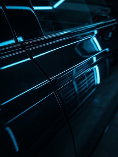 Macro shot of a glossy black car door panel under bright neon blue linear inspection lights, showing a perfectly smooth metallic surface with sharp reflections, high contrast automotive photography, 35mm
