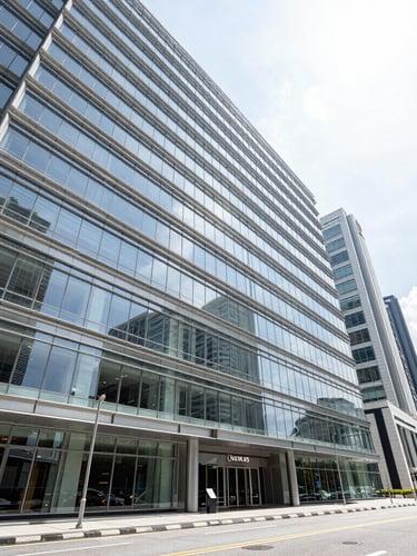 Wide-angle architectural photography of a modern glass commercial retail hub in Kuala Lumpur during bright natural daylight, clean structural lines, high-contrast shadows