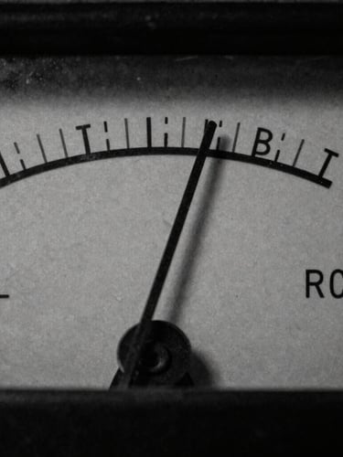 Gritty macro close-up of a vintage sound level meter needle vibrating, dramatic low-key side lighting, charcoal black and raw paper tones, 35mm film grain