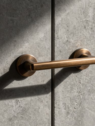 Bespoke architectural macro detail of a bronze door handle mounted on raw textured concrete wall, sharp shadows, minimalist, high-end editorial
