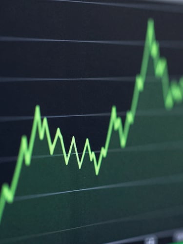 Macro crop of a high-contrast data visualization screen showing sharp green line charts against a dark slate background, cool studio lighting, deep shadows