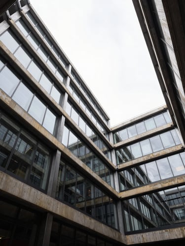 Wide-angle architectural photograph of high-contrast steel and glass framing, crisp overcast daylight reflecting off structural elements.