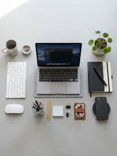 Overhead flatlay of organized workspace accessories, crisp daylight, minimalist light gray backdrop, sharp focus