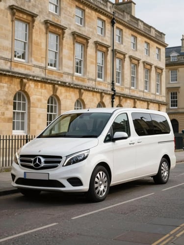 A clean, branded professional vehicle parked neatly on a quiet, historic stone street in Bath, with soft natural daylight highlighting the elegant architecture in the background.