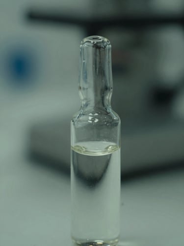 Macro shot of a clear liquid chemical sample in a glass vial, crisp laboratory lighting, muted greens, sharp focus, technical precision.