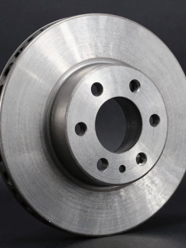 Macro detail shot of a metallic truck brake disc showing precision machining, clean steel textures, high-contrast studio lighting, dark charcoal background