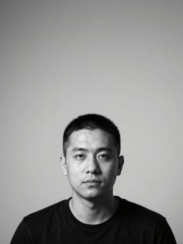 Stark minimalist black and white portrait of a creator, high-contrast direct studio lighting, orthographic framing, clean geometric composition, negative space.