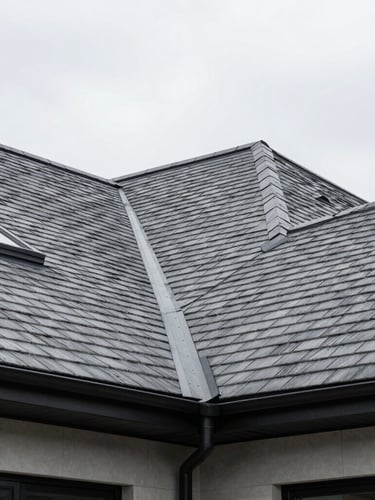 Low-angle architectural shot of a modern luxury home with a pristine slate-gray shingle roof, crisp overcast daylight, sharp focus, 35mm