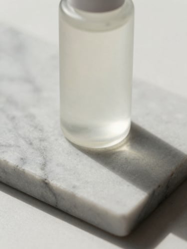 Extreme close-up of a pristine glass skincare bottle on a raw marble slab, soft natural daylight, long shadows, minimalist editorial photography