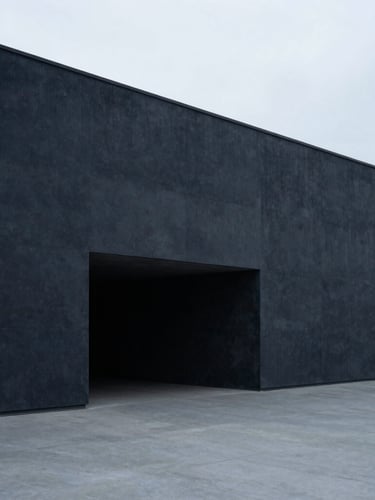 Wide-angle architectural perspective of a minimalist concrete structure, sharp clean lines, cool diffused overcast daylight, desaturated navy and slate tones, sharp focus, 35mm