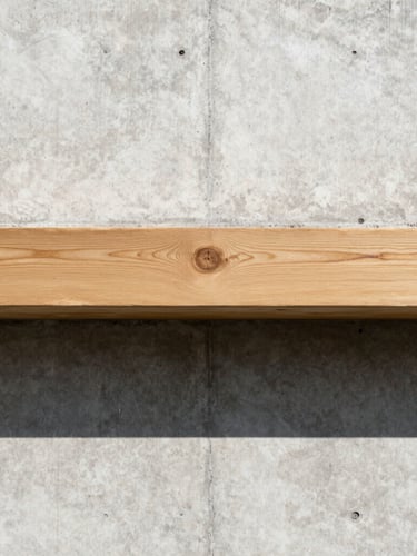 Straight-on architectural elevation of a concrete wall meeting a perfectly aligned raw oak timber beam, sharp daylight casting graphic shadows, technical precision layout.