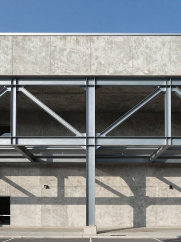 Straight-on architectural elevation of a modern concrete and steel commercial building, bright daylight, sharp shadows, structural steel beams visible, clean geometric lines.