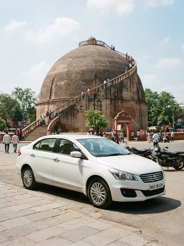 Clean white sedan parked in front of Golghar in Patna, Bihar, under bright natural daylight, wide shot.