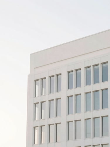 Minimalist architectural photography of a sun-drenched modern Orlando office building with clean lines, soft morning daylight, low-saturation pastel tones, crisp white background, high-key lighting, 35mm lens