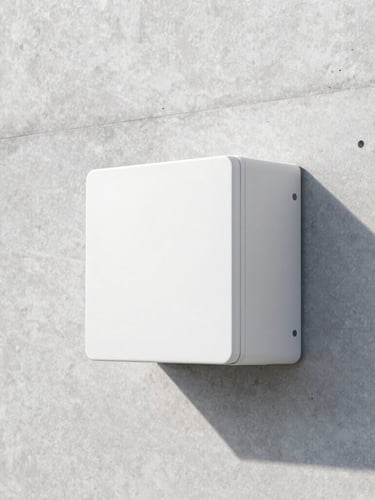 Low-profile white mini-split head mounted high on a minimalist concrete wall, bright daylight casting soft shadows, crisp architectural photography
