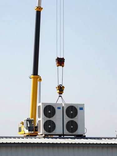A mobile crane lifting a heavy industrial climate control unit onto a steel-reinforced roof curb, bright daylight, high contrast