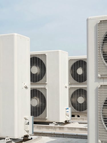 Crisp architectural photography of high-capacity rooftop HVAC condenser units framed against a bright daylight sky, clean industrial lines, high contrast, 35mm lens.
