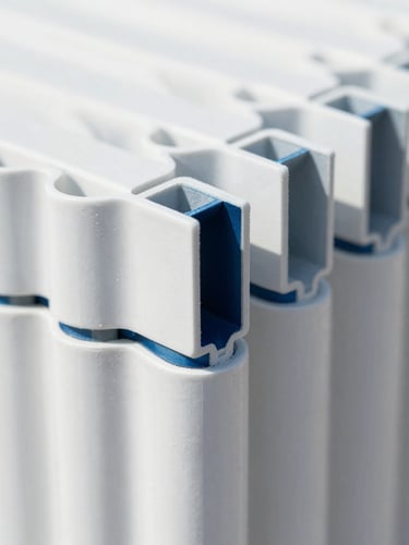 Close-up of a clean welded UPVC joint, showing multi-chambered profiles, bright daylight, crisp white and deep blue tones, sharp focus, architectural alignment.