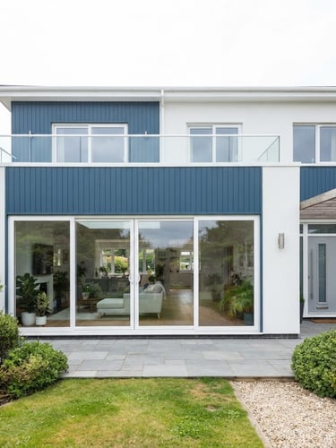 Wide shot of a modern residential facade with large, clean UPVC sliding doors installed, bright indirect daylight, architectural alignment, crisp white and deep blue tones.