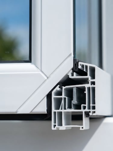 Close-up of a clean welded UPVC casement window joint, bright daylight, crisp white and deep blue tones, sharp focus, 35mm lens, showing multi-chamber insulation