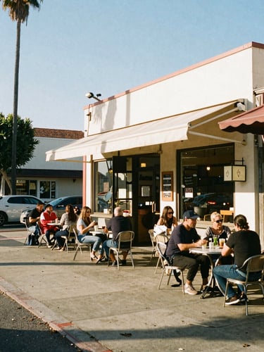 Warm afternoon sun lighting up a busy storefront cafe along Sawtelle Boulevard, local patrons at outdoor tables, 35mm film look.