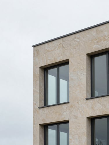 Sober minimalist architectural detail of a contemporary stone and glass facade in Luxembourg, soft overcast daylight, cool slate tones, 35mm lens