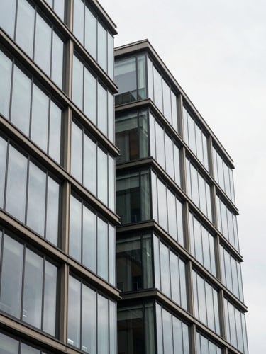 Architectural close-up of a modern glass and steel financial building in Luxembourg, sharp geometric lines, soft overcast daylight, elegant composition, 35mm lens