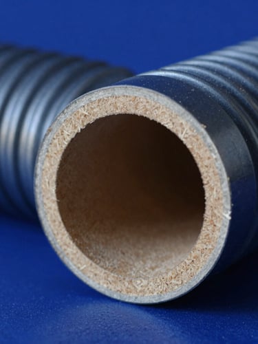 Macro shot of a corrugated flute cross-section under high-contrast blue laboratory lighting, showing paper texture and structural fluting, 35mm