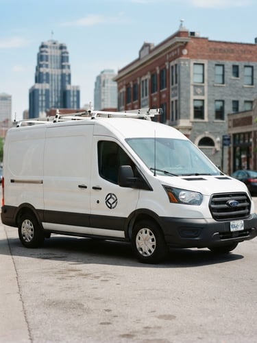 A professional corporate photograph of a clean white field operations vehicle with subtle corporate branding, parked in bright natural daylight on a Kansas City street, cool slate and navy tones, sharp focus, 35mm, portrait framing.