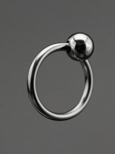 Macro studio shot of a healed helix piercing with a sleek titanium ring, high-contrast monochrome, sharp directional light, professional studio setting, 85mm