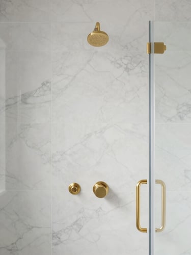 Straight-on architectural elevation of a finished custom walk-in shower, flawless white marble tile with mitred edges, gold fixtures, soft natural lighting.
