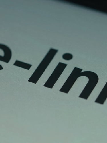 Macro close-up of a modern e-ink display showing crisp technical typography, cool diffused screen-glow, slate and teal tones.