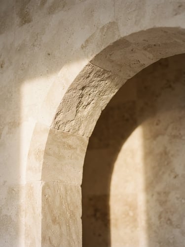Close-up detail of a modern limestone architectural archway, soft warm morning light casting long elegant shadows, minimalist aesthetic