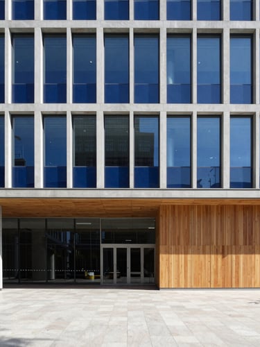 Wide shot of a modern, clean corporate headquarters lobby with architectural grid lines, crisp daylight, and a subtle hint of deep royal blue accents. No people visible. Focus on structure and precision.